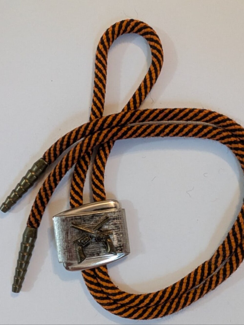 Guns Crossed Western Bolo Tie Slide with  Bronze Tips and orange-black cord